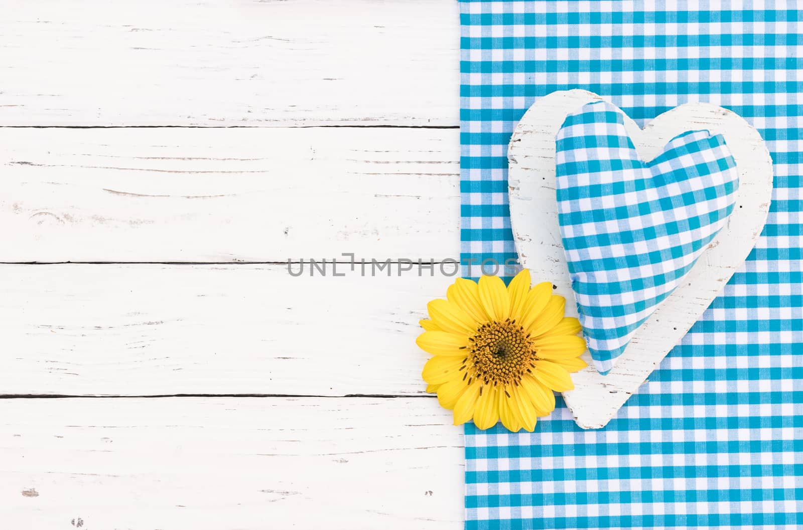 Baby boy birthday greeting card background with blue heart, yellow blossom and copy space

