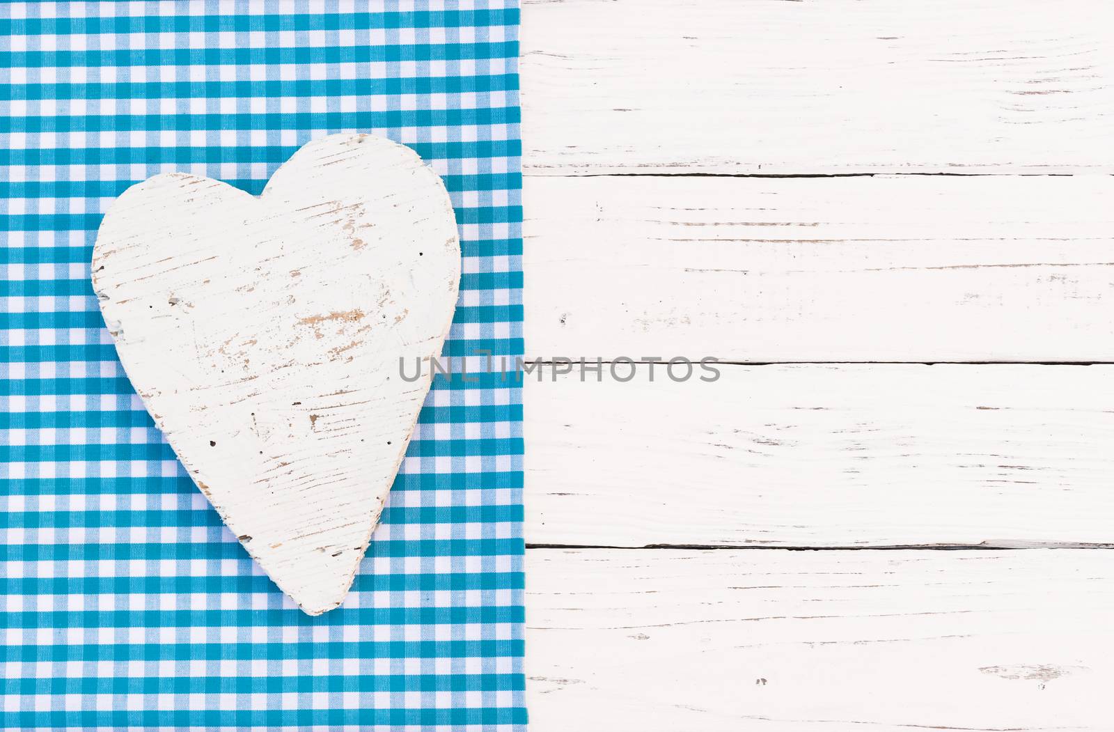 White heart on light blue background and copy space