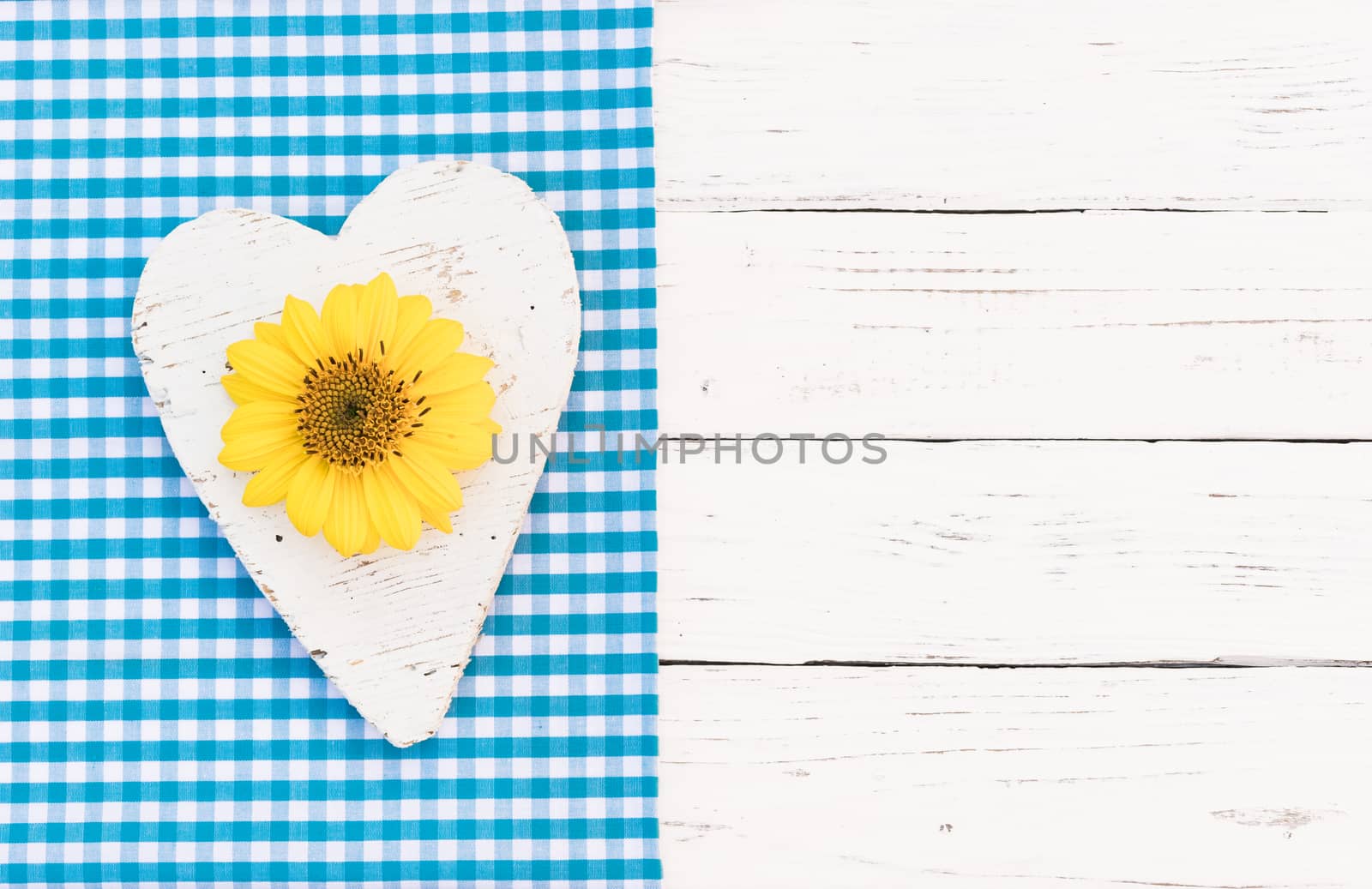 Rustic white wooden heart with yellow sunflower with copy space