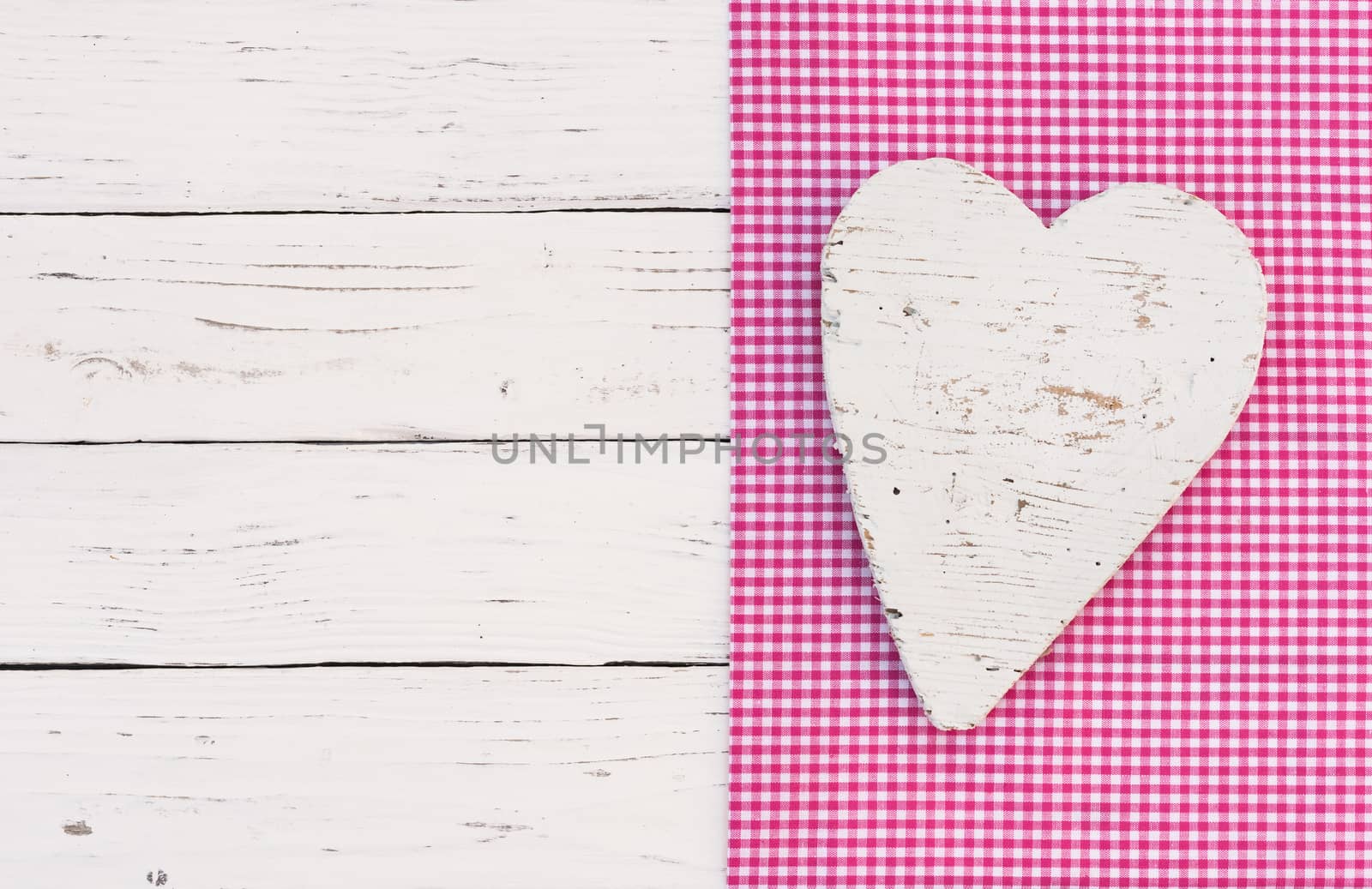 White heart on pink fabric background with copy space

