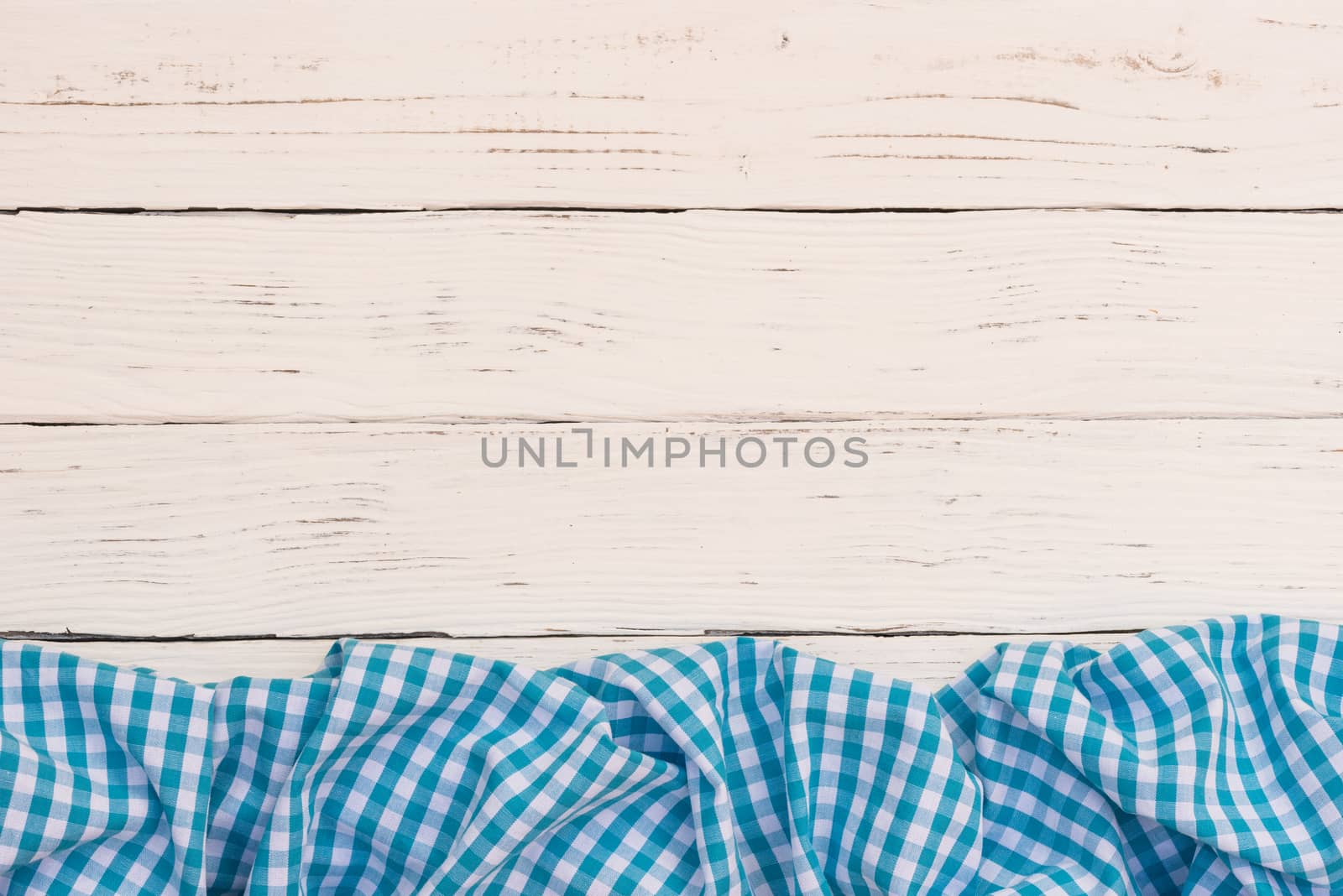 White wooden table background rustic texture, with blue checkered tablecloth, high angel view

