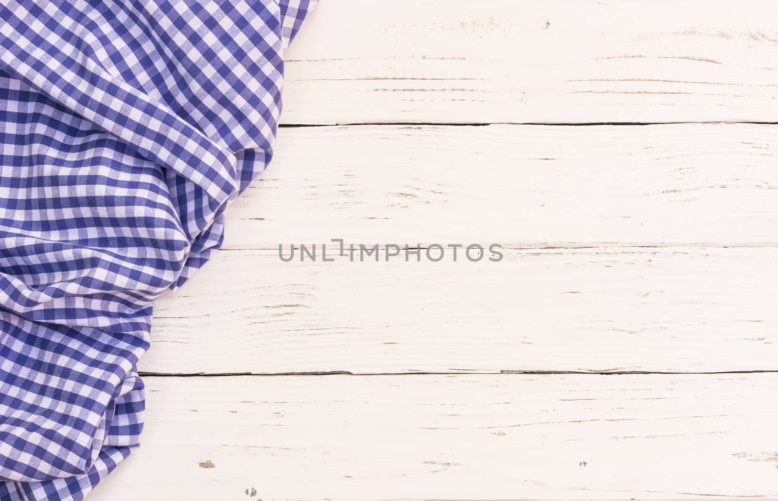 White wooden table background rustic texture, with blue checkered tablecloth, high angel view