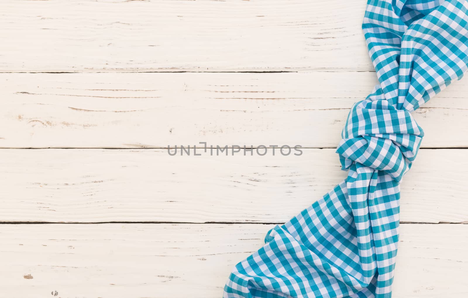 White wooden table background with blue rustic tablecloth and serving size