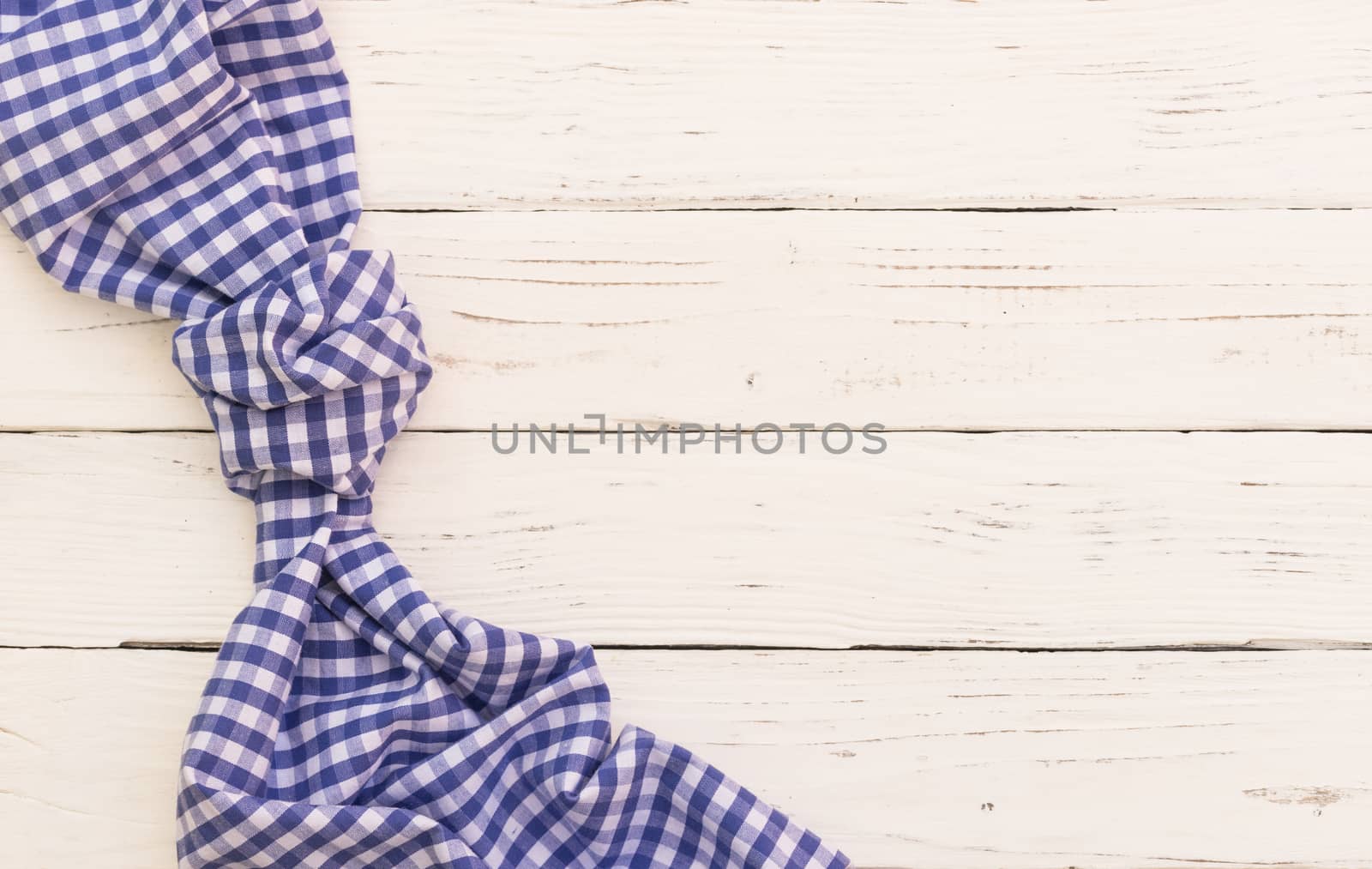 White table background with blue checked tablecloth, top view