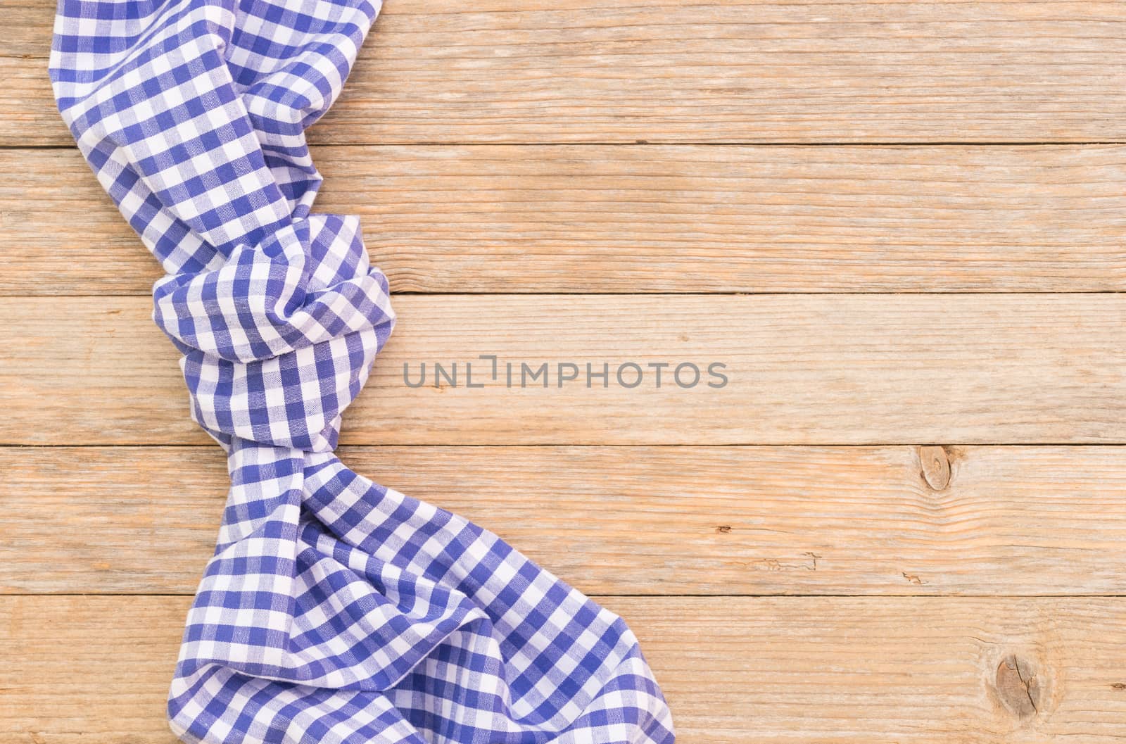 Wood table background with blue checkered tablecloth, high angel view