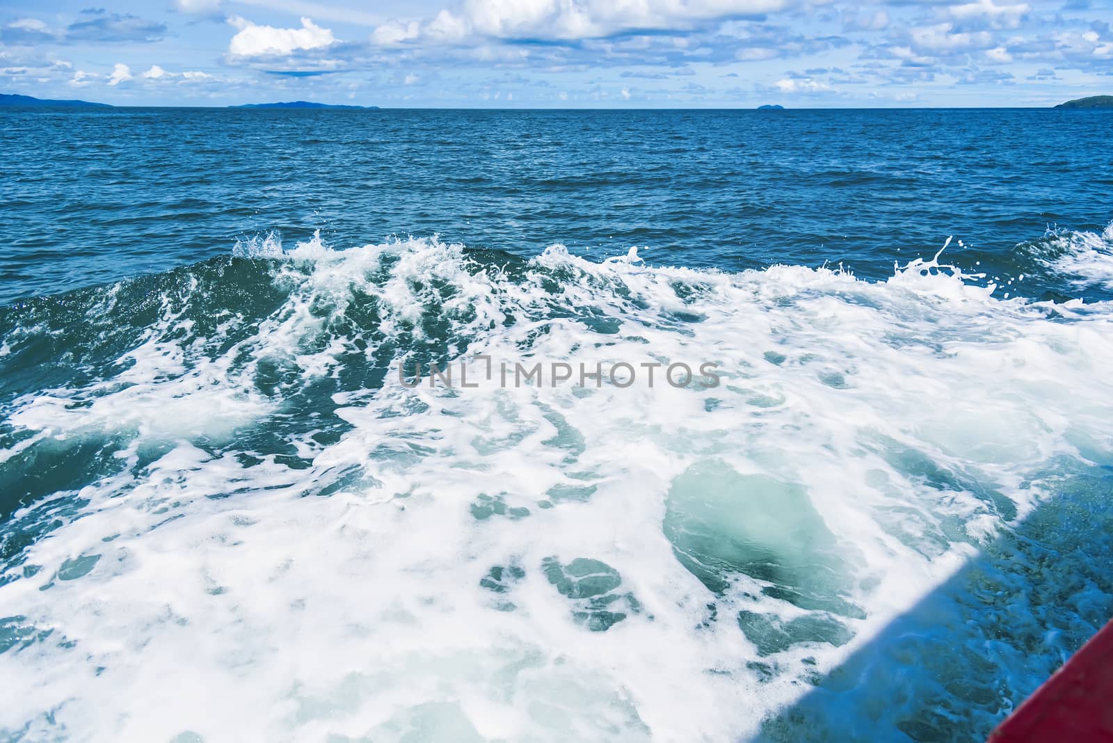 Water blue ocean splash and boat in the sea way ,Waves splashing on the side of ship