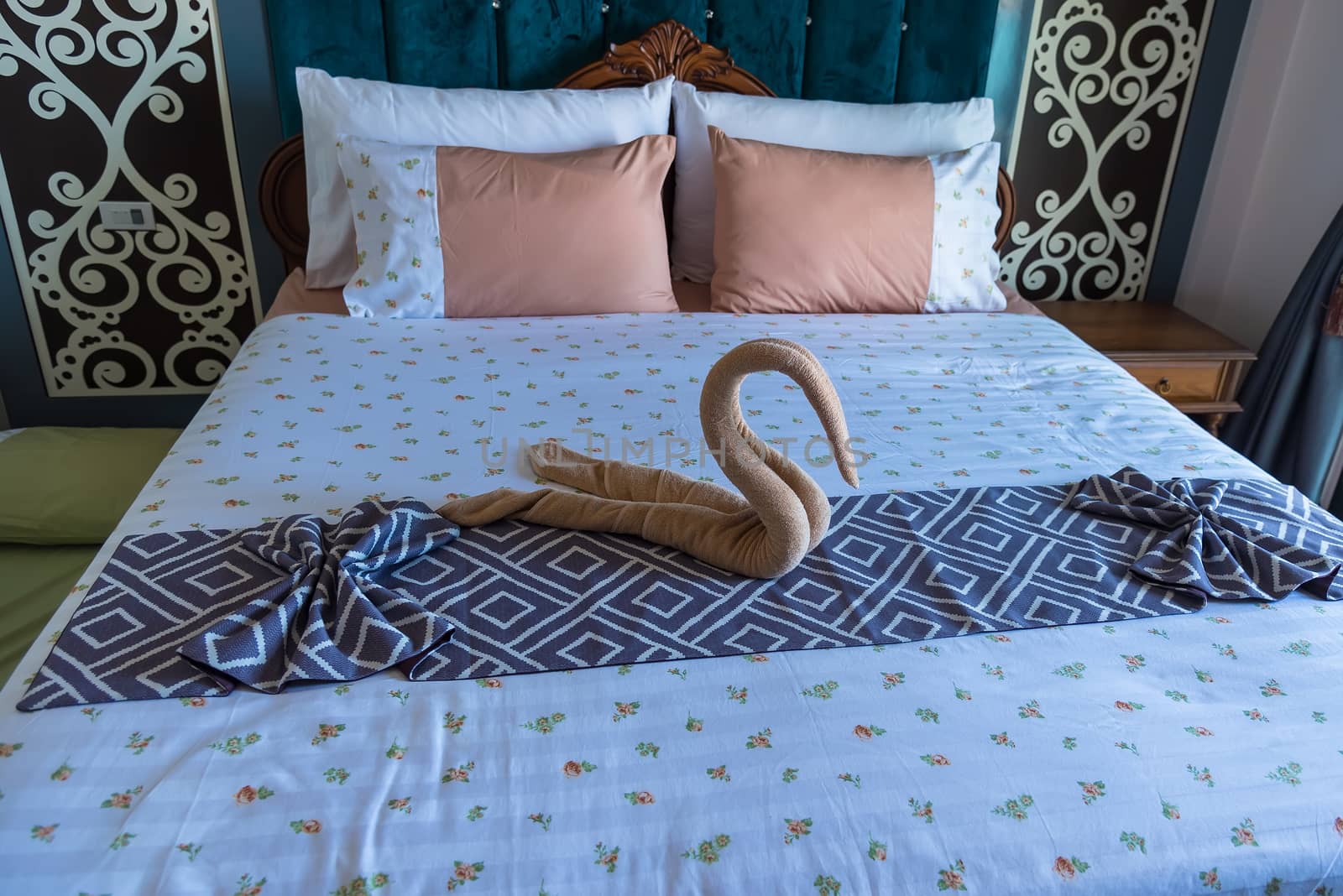 Swan shaped towel on the bed.concept travel.