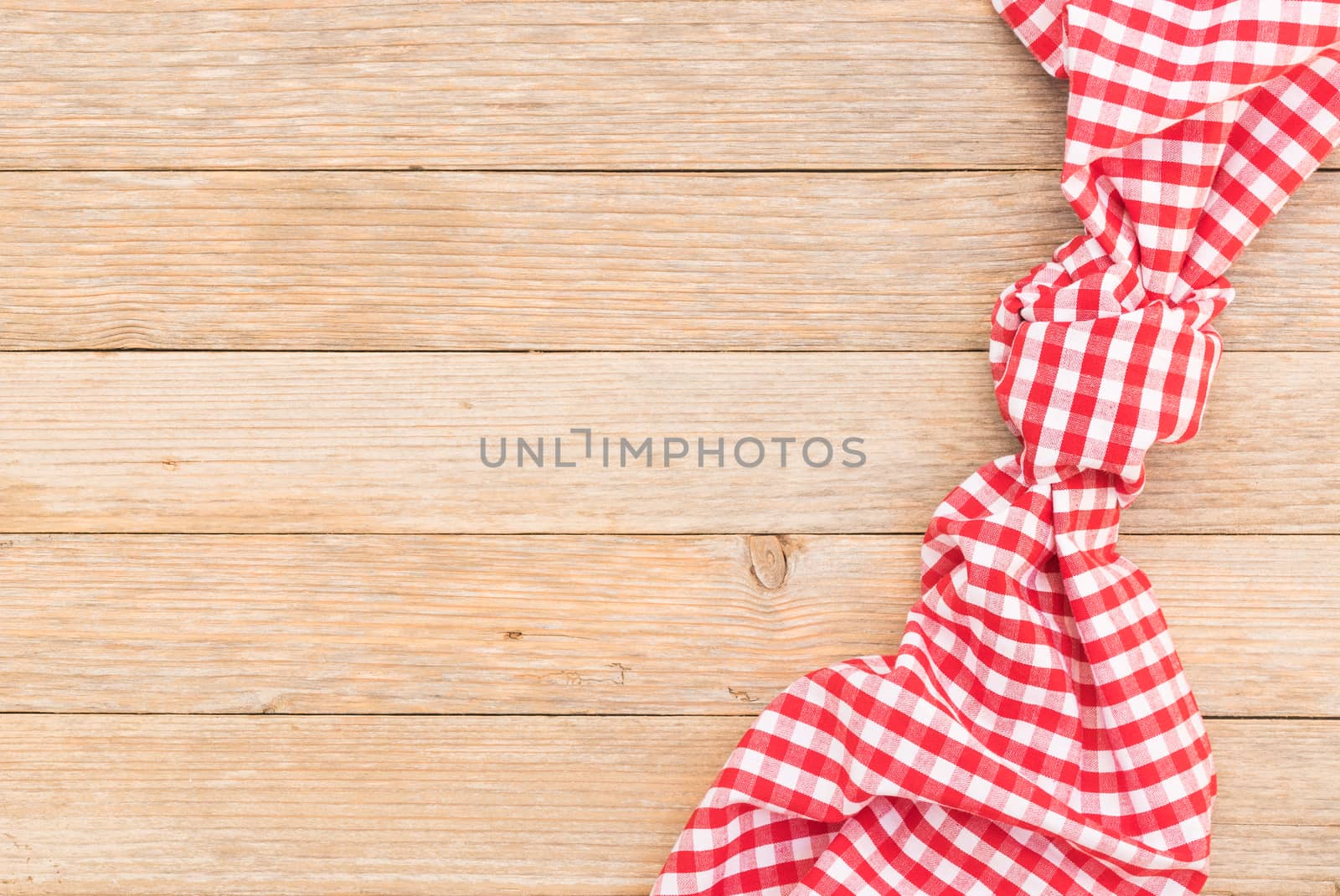 Wood table background with red checkered tablecloth, high angel view