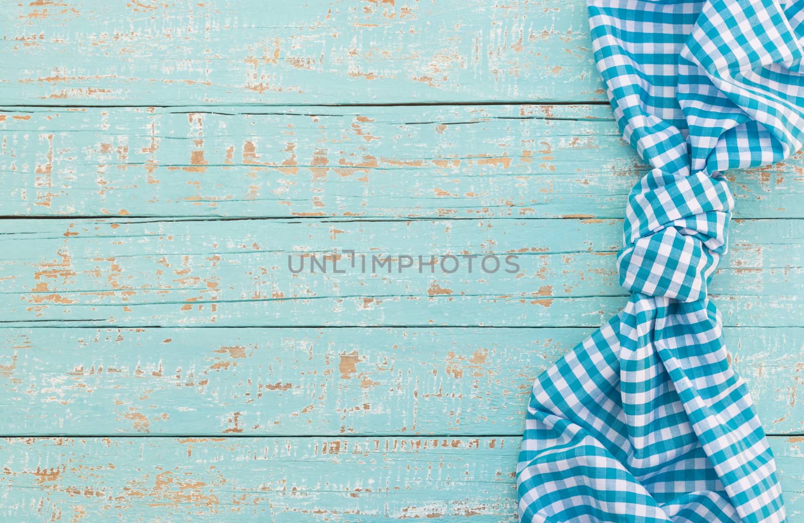 Blue wood table background rustic texture, with blue checkered tablecloth, high angel view

