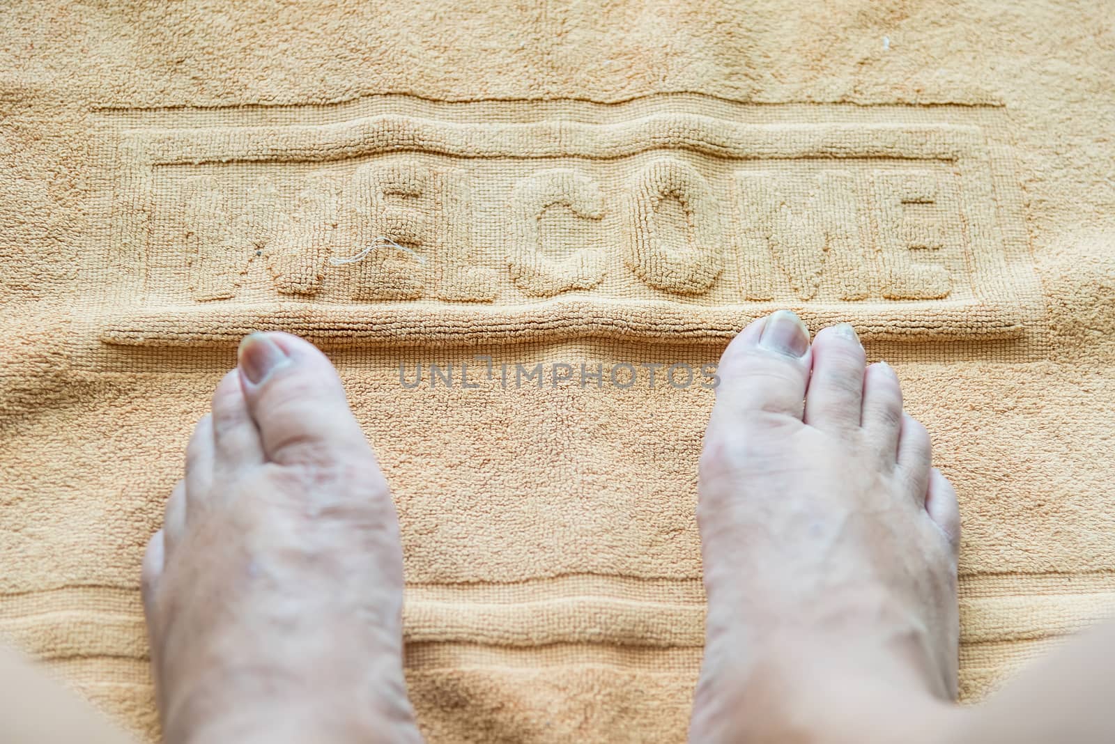 Foot towel with welcome sign on the bathroom floor by Bubbers