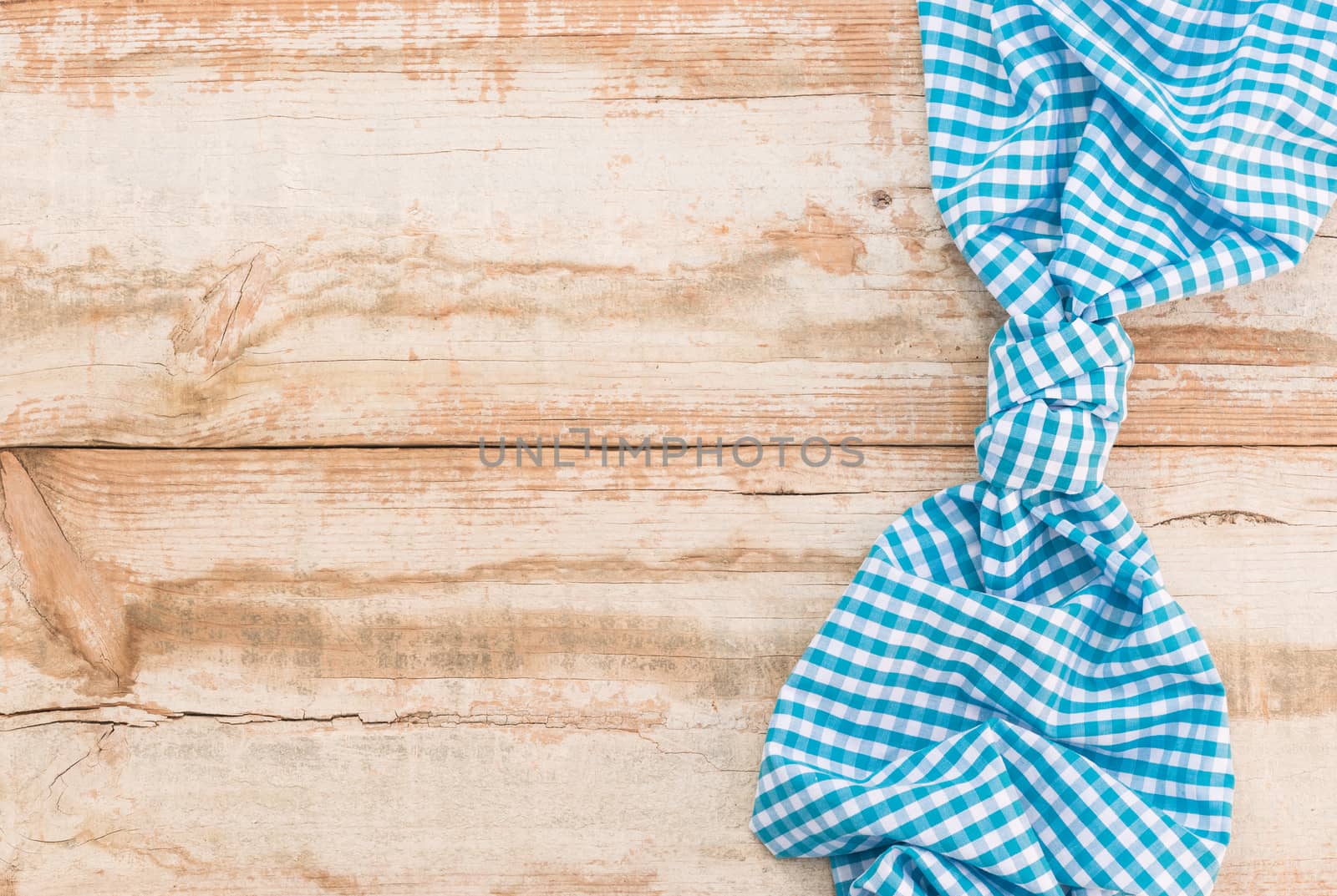 Wooden table background rustic texture, with blue checkered tablecloth, high angel view