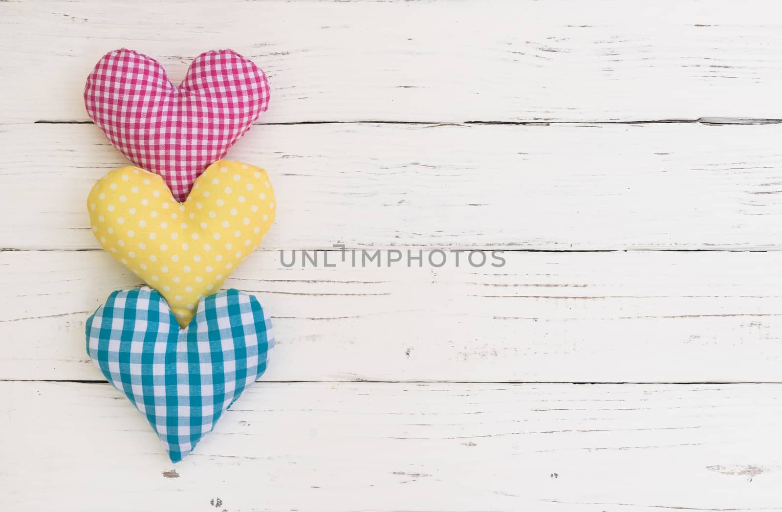 Romantic fabric hearts border for Valentine card on white wood background