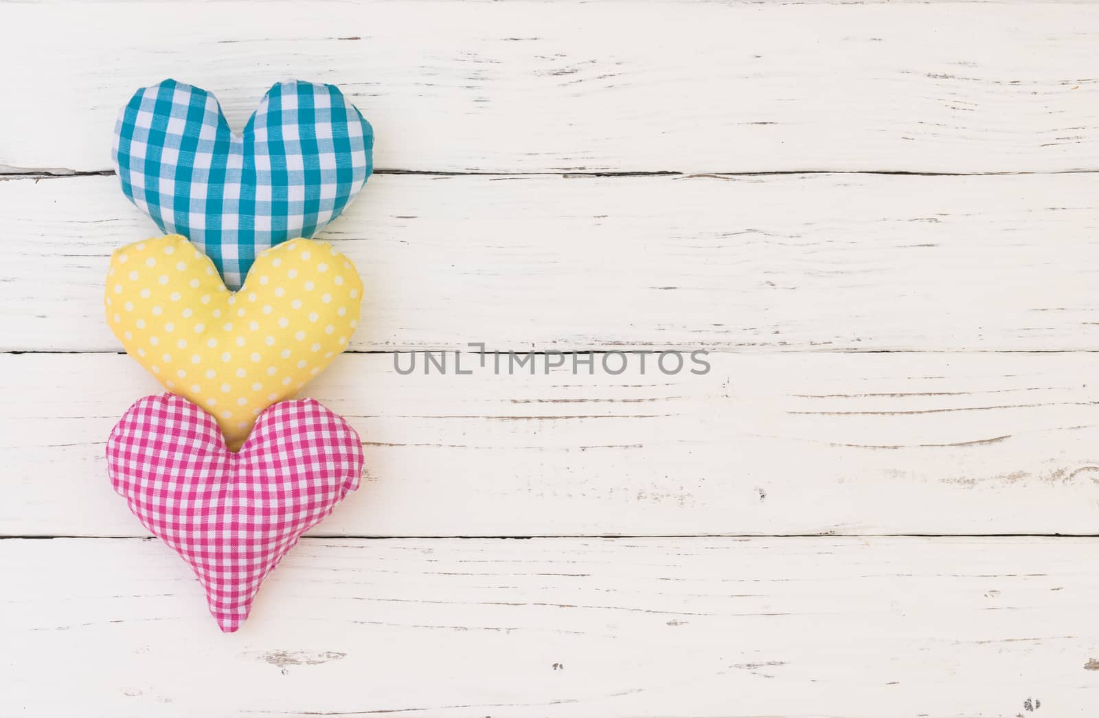 Three colorful hearts border on white background with copy space