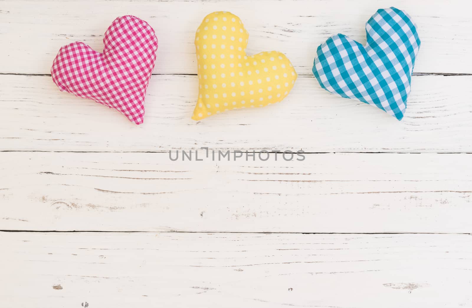 Colorful hearts decoration on white wood background with copy space