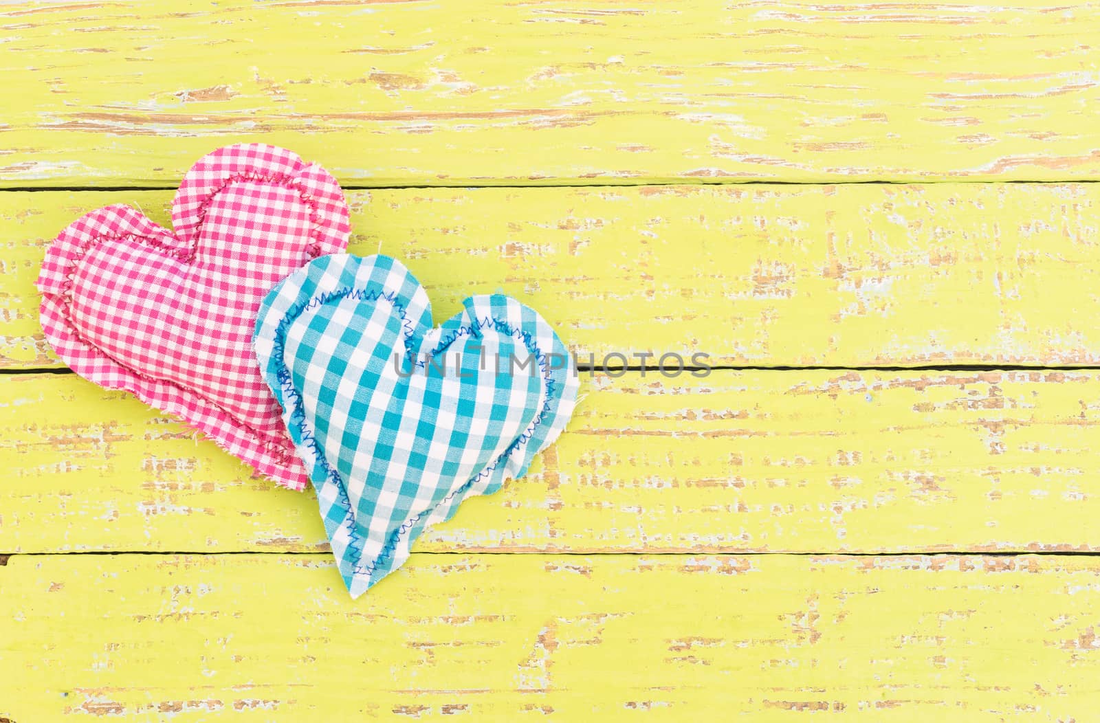 Pink and blue heart on wooden background with copy space