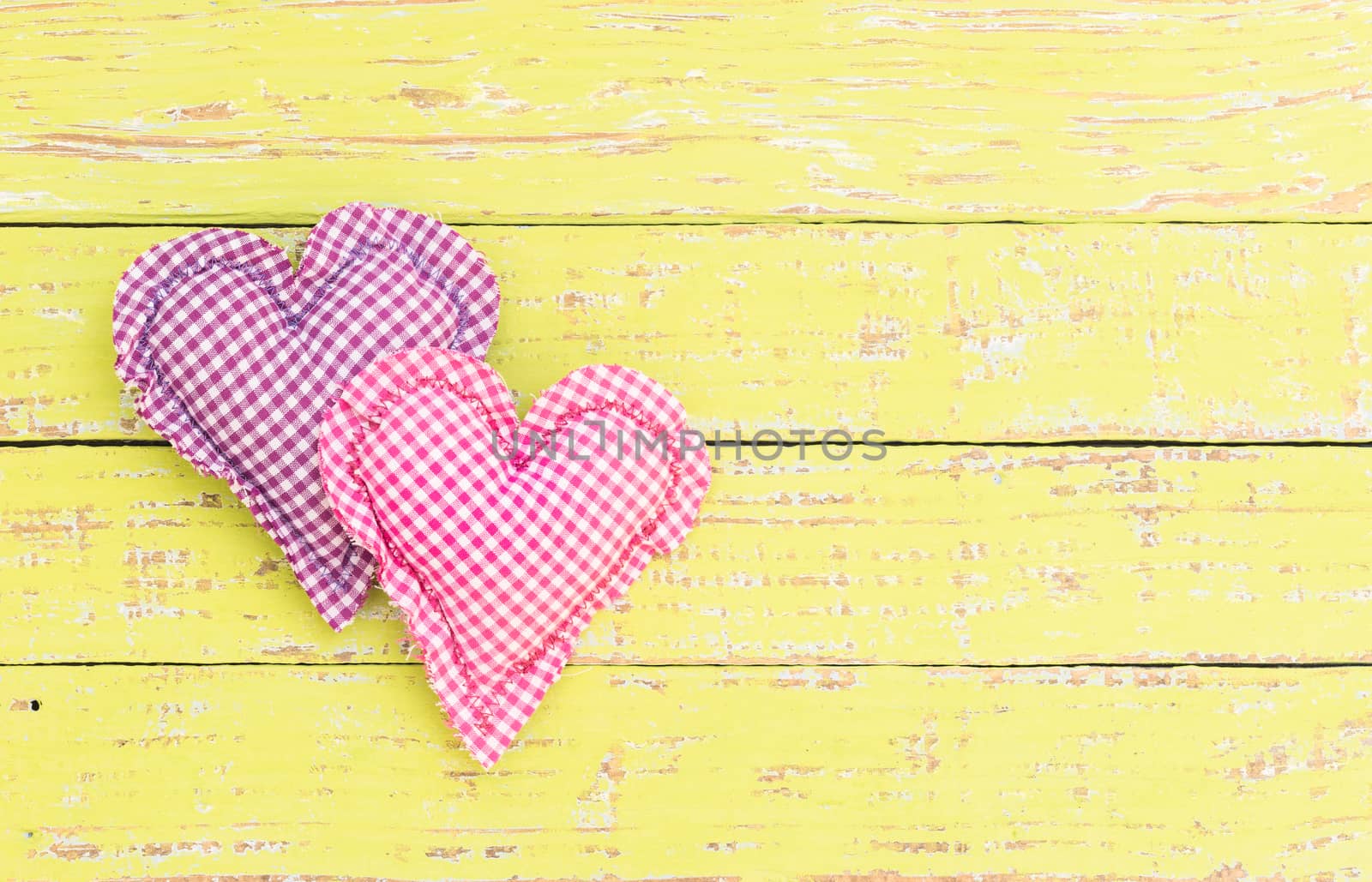 Pink and purple heart on wooden background with copy space