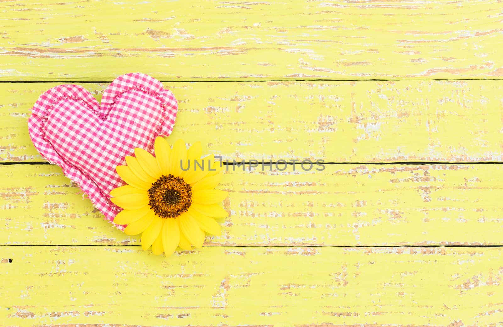 Rustic pink heart with flower on wooden background with copy space