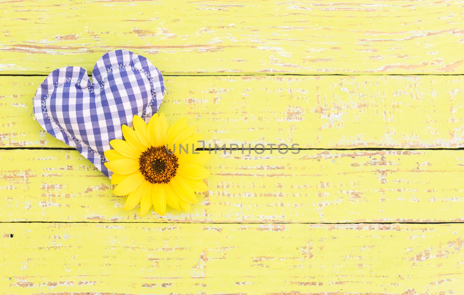 Rustic blue heart with flower on wooden background with copy space