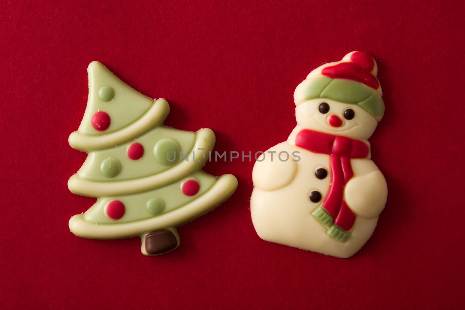 Christmas chocolate bonbons on red background