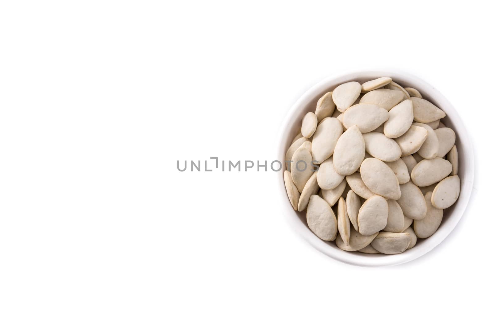 Pumpkin seeds in bowl isolated on white background