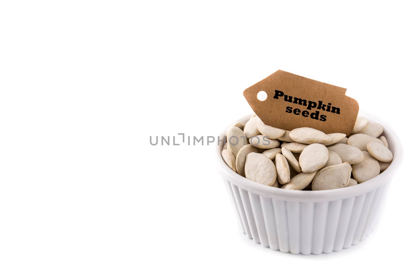 Pumpkin seeds in bowl isolated on white background.