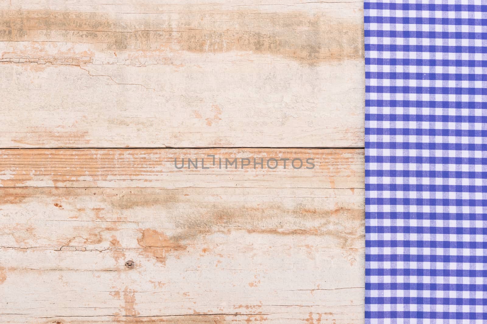 

Wooden table background rustic texture, with blue checkered tablecloth, high angel view