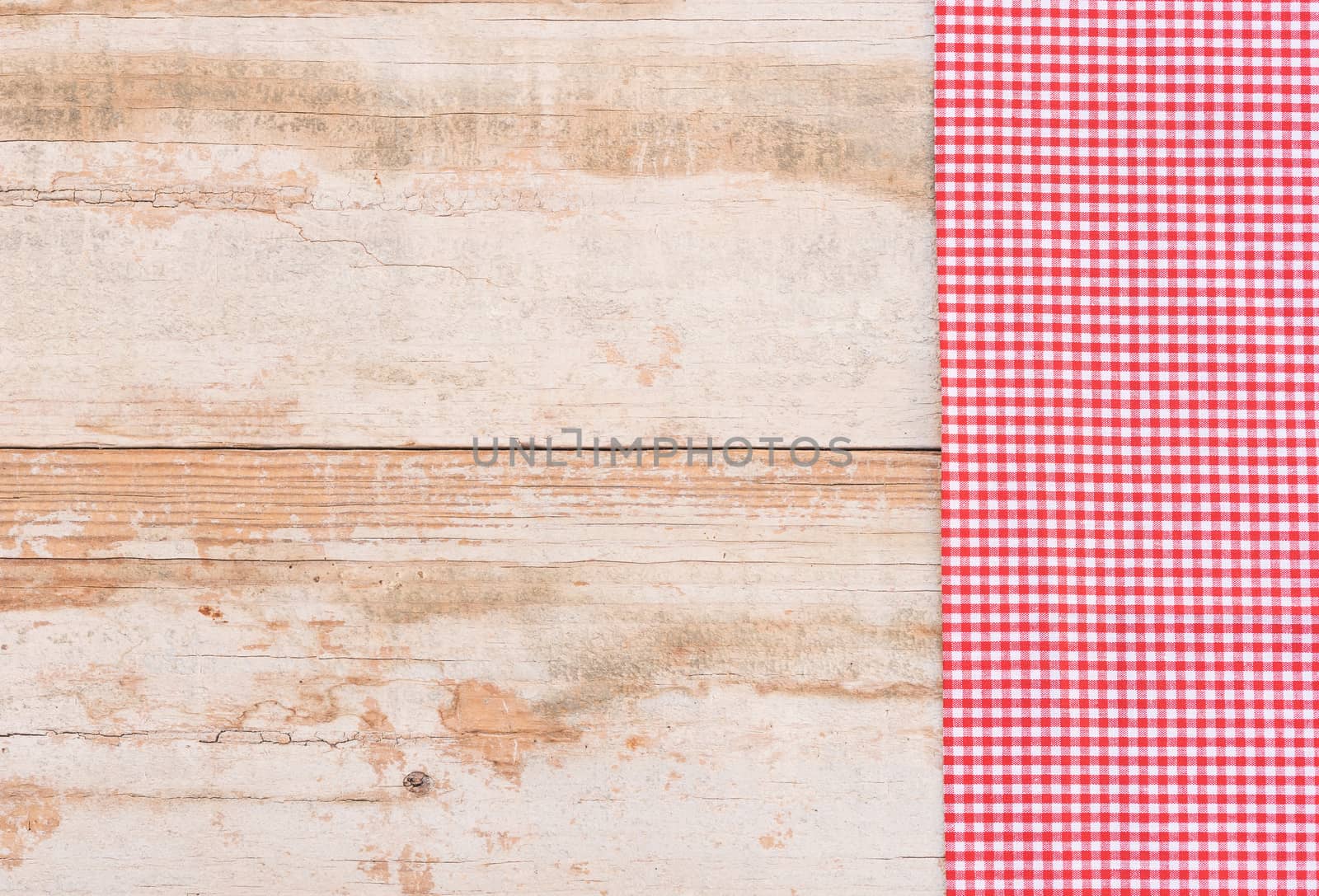 Checkered tablecloth on rustic wooden table background
