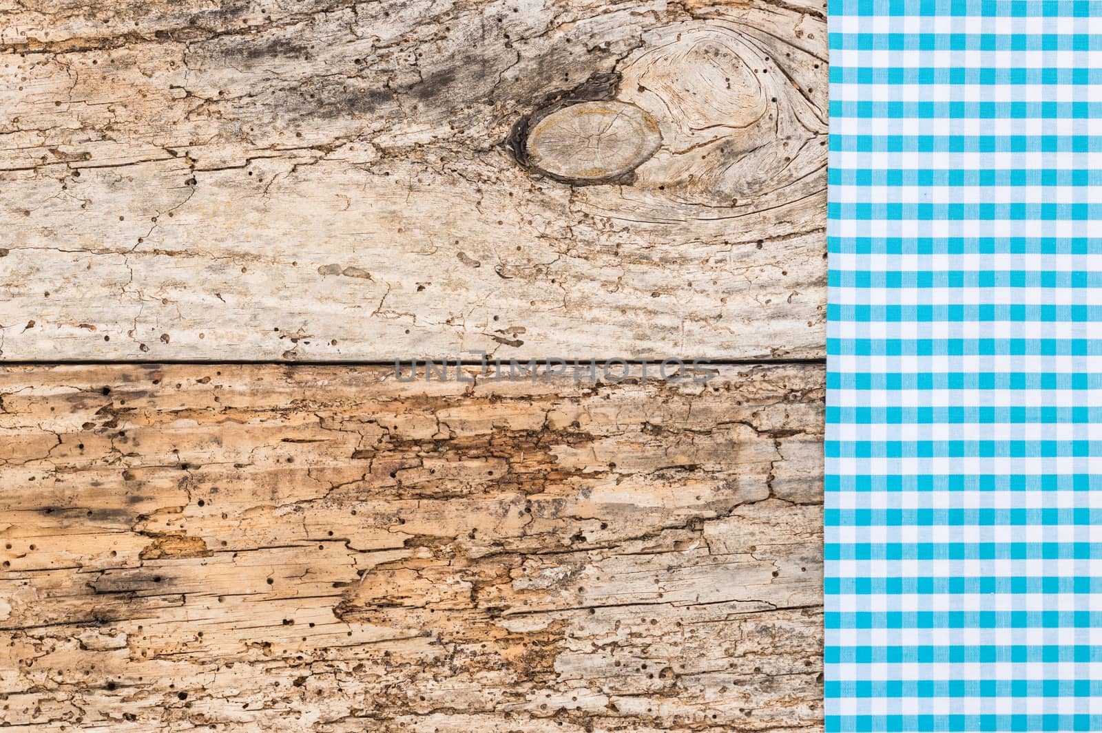 Old wooden table background rustic texture, with blue checkered tablecloth, high angel view