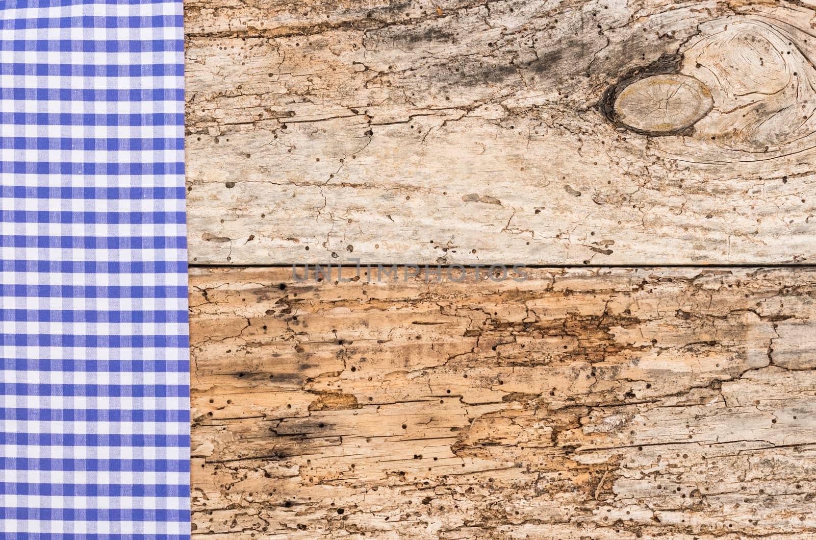 Old wood table background rustic texture, with blue checkered tablecloth, high angel view