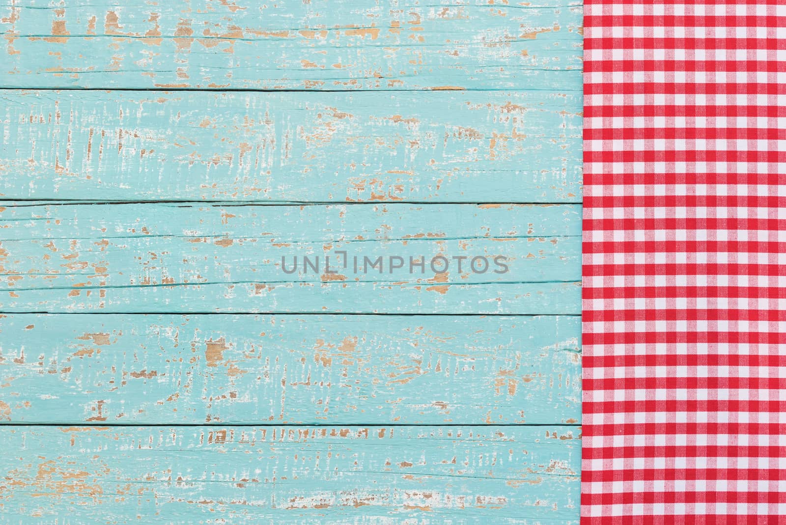 Checkered tablecloth on rustic blue wooden table background