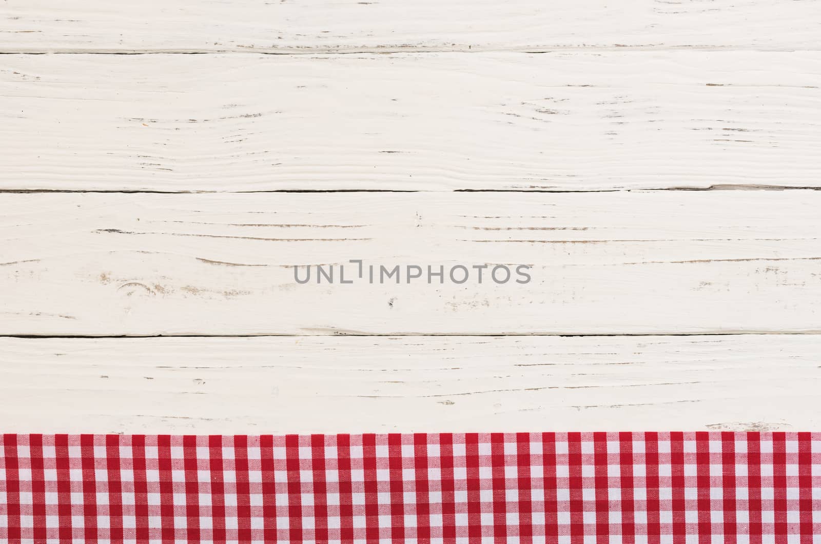 Rustic white kitchen table background with red checked tablecloth