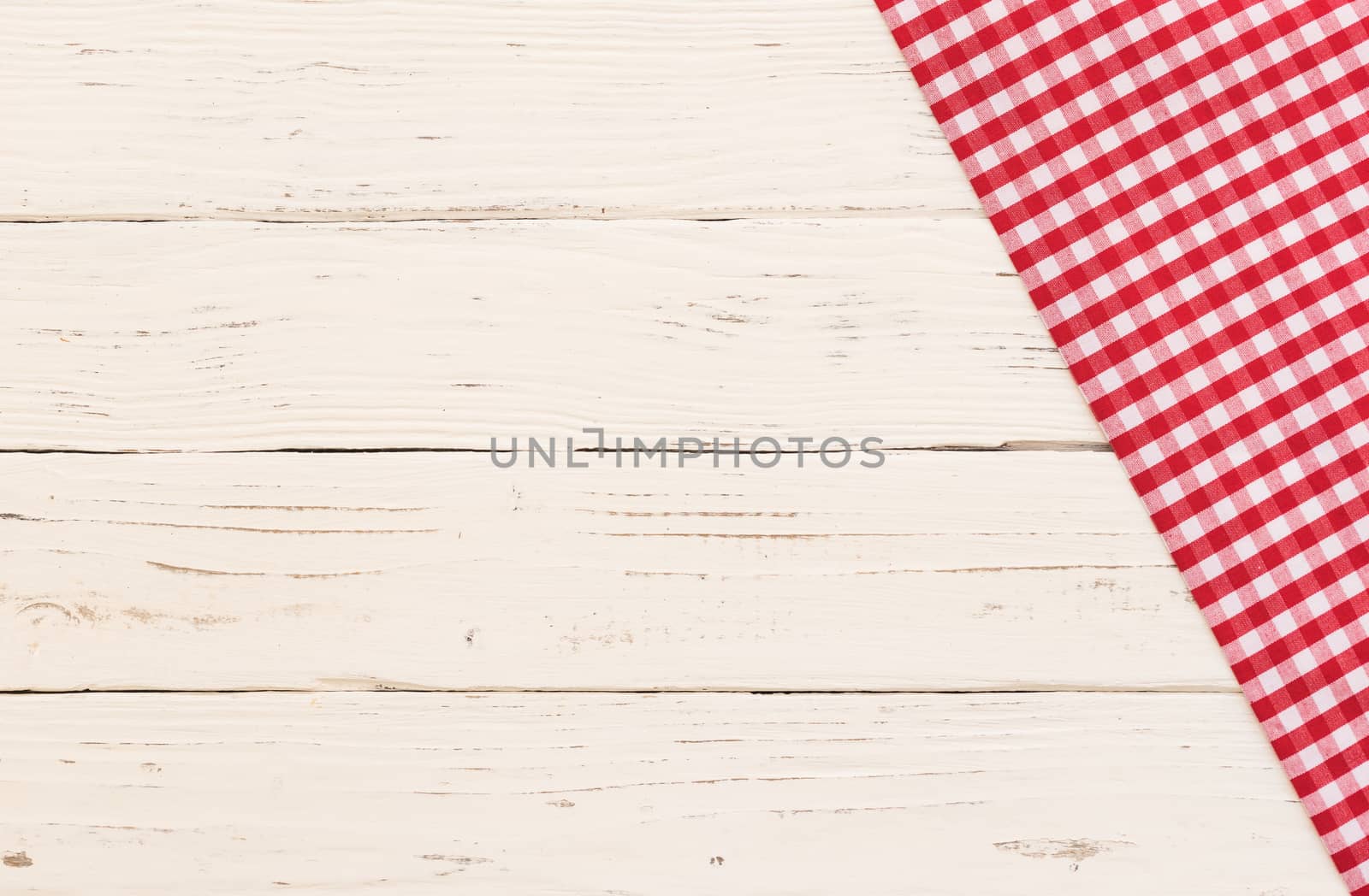 Rustic white kitchen table with red checked tablecloth and serving size