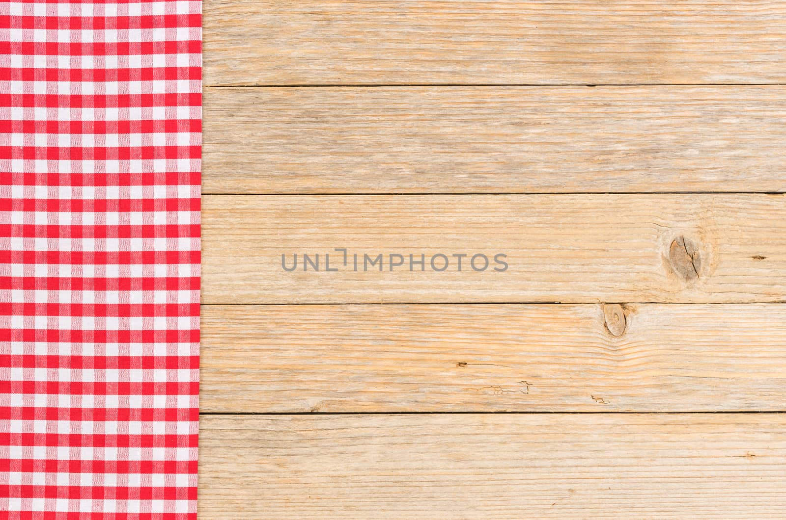 Rustic kitchen table background with red checked napkin