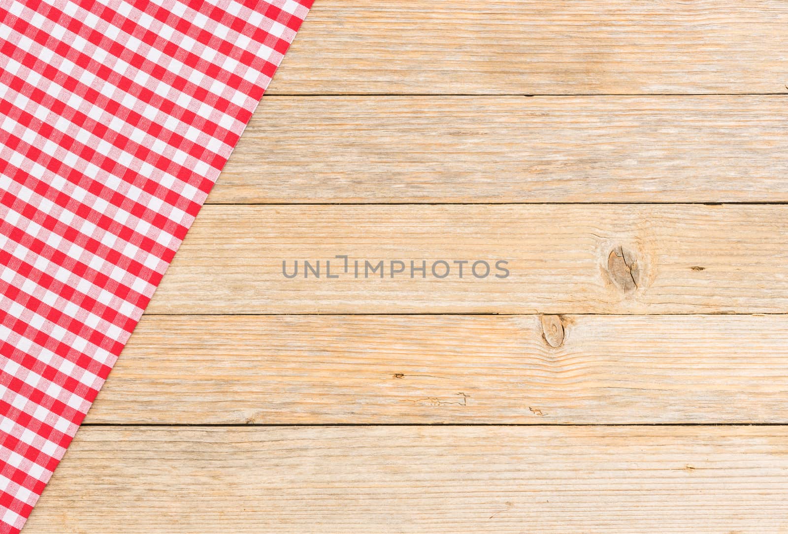 Rustic kitchen wood table background with red checked tablecloth
