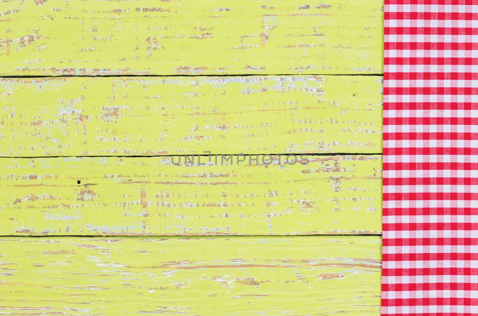 Red checkered napkin on green wooden kitchen table background with serving size