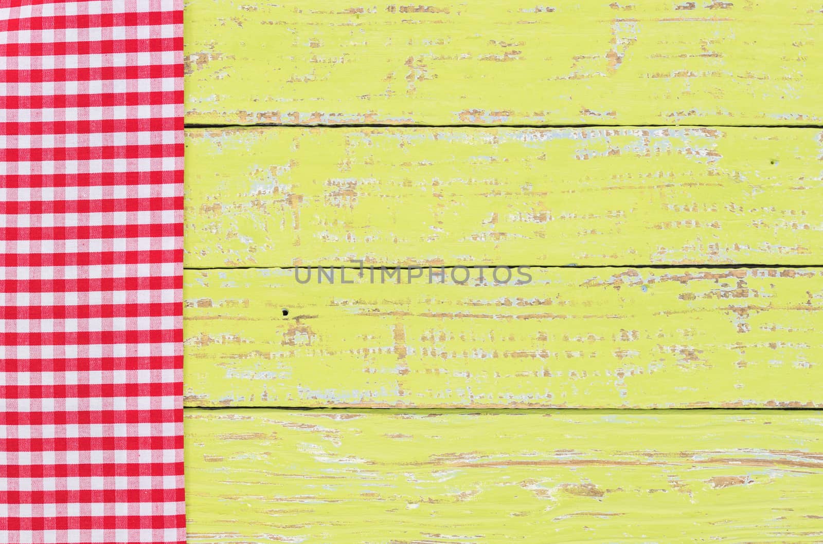 Green table background with rustic red tablecloth