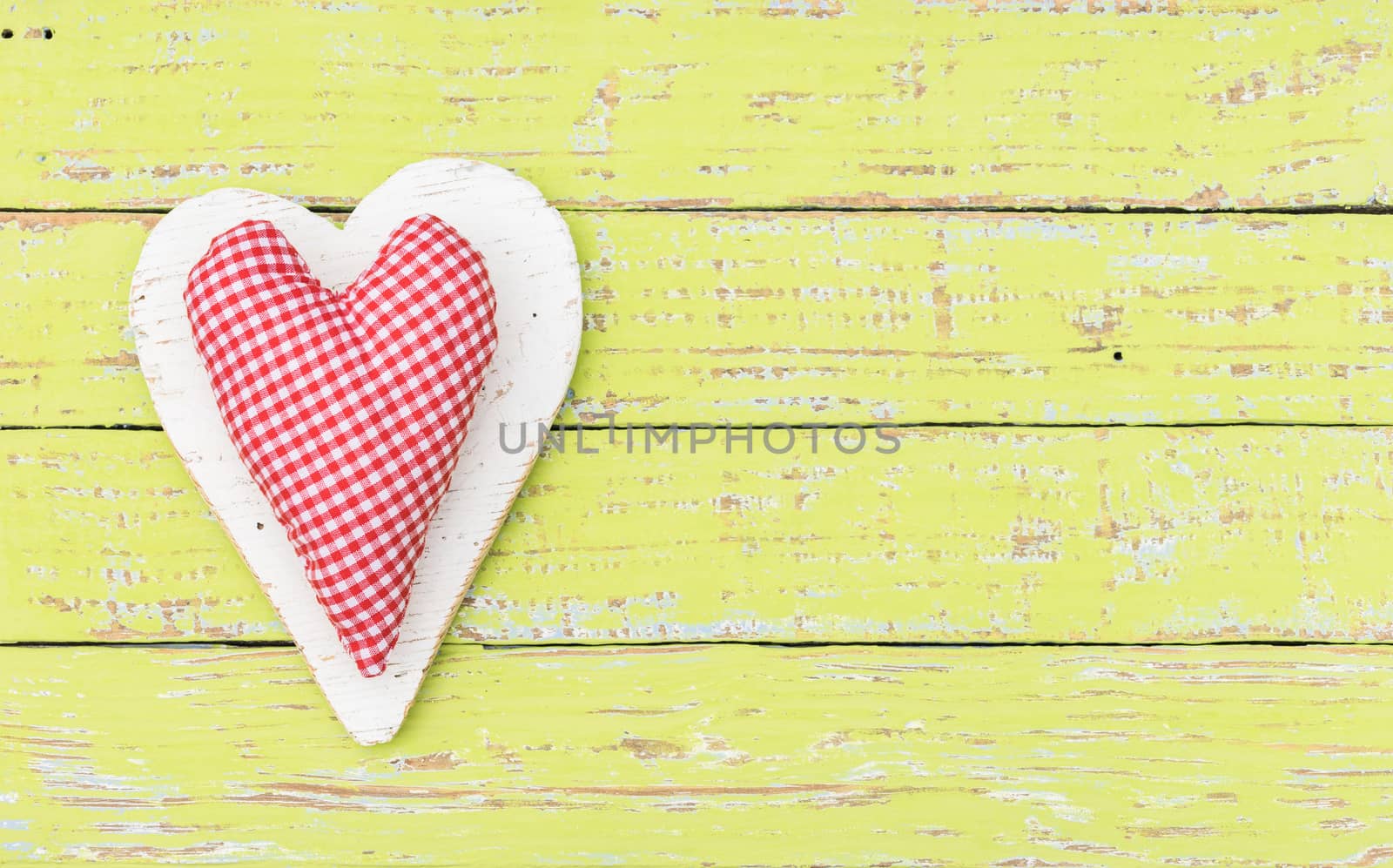 Romantic red heart on yellow wood background for Valentine card with copy space