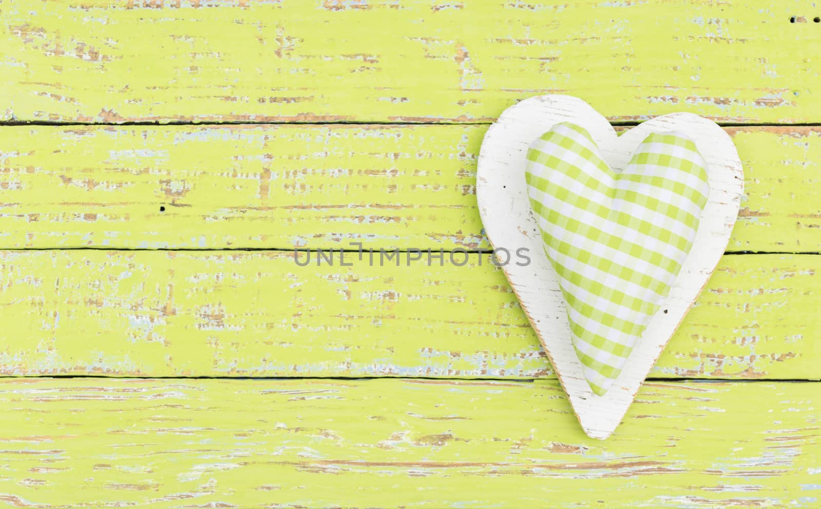Rustic green heart on wood background with copy space