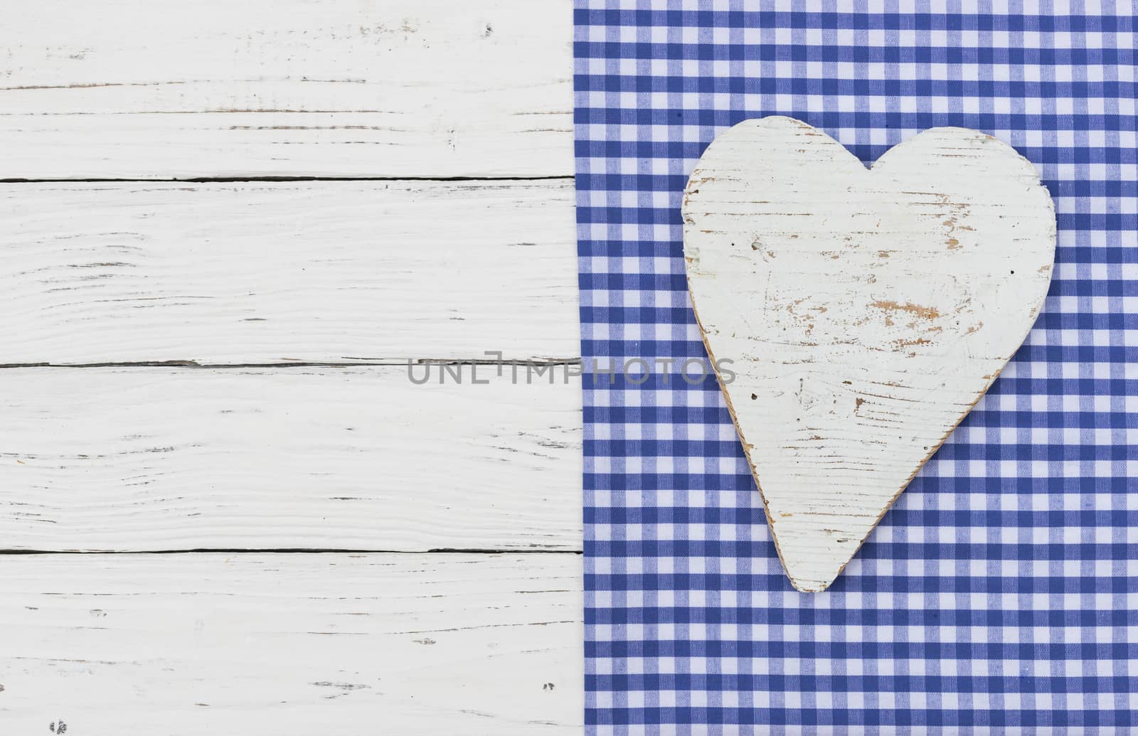 Rustic heart on blue fabric background by Vulcano