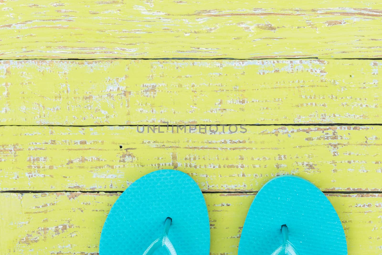 Summer vacation travel concept background with turquoise beach sandals on colored wood