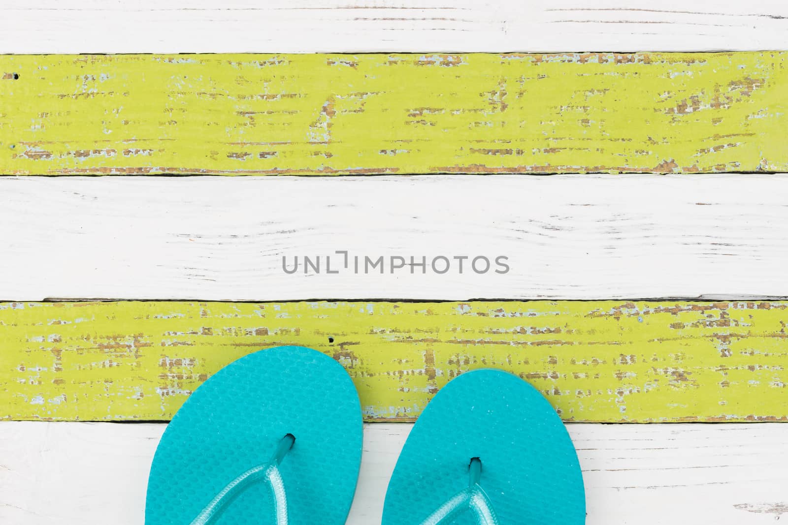 Summer holiday concept background with turquoise beach sandals on wooden deck 

