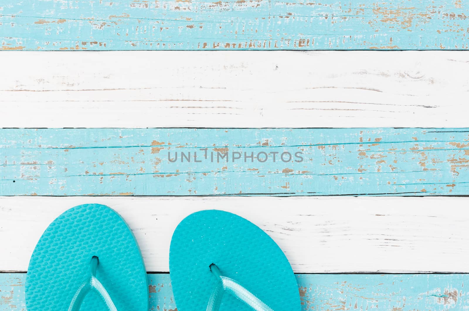 Summer holiday concept background with turquoise beach sandals on wooden deck 