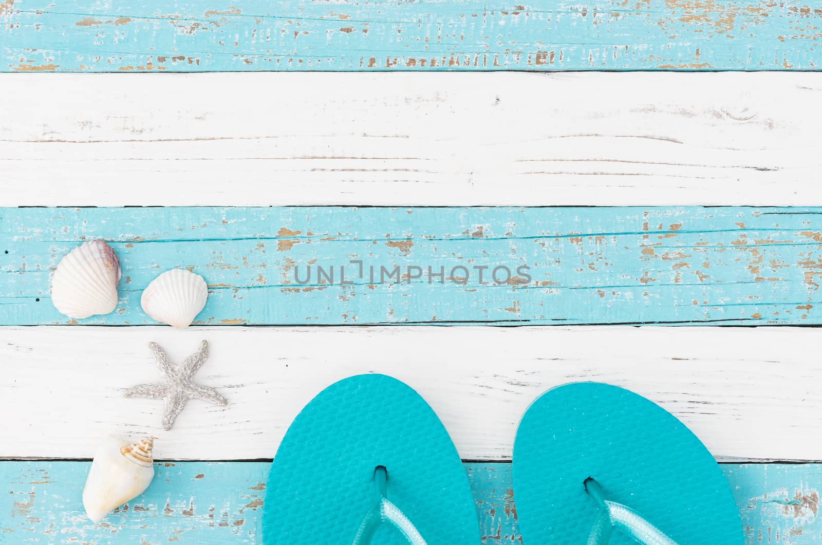 Beach sandals and seashells summer holiday background with copy space