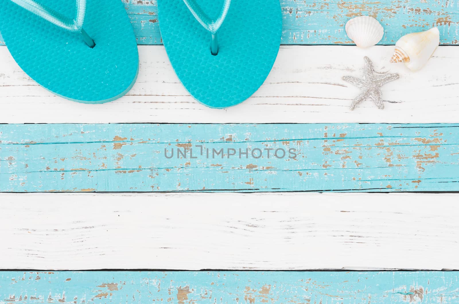 Summer vacation travel concept background with turquoise beach sandals on colored wood