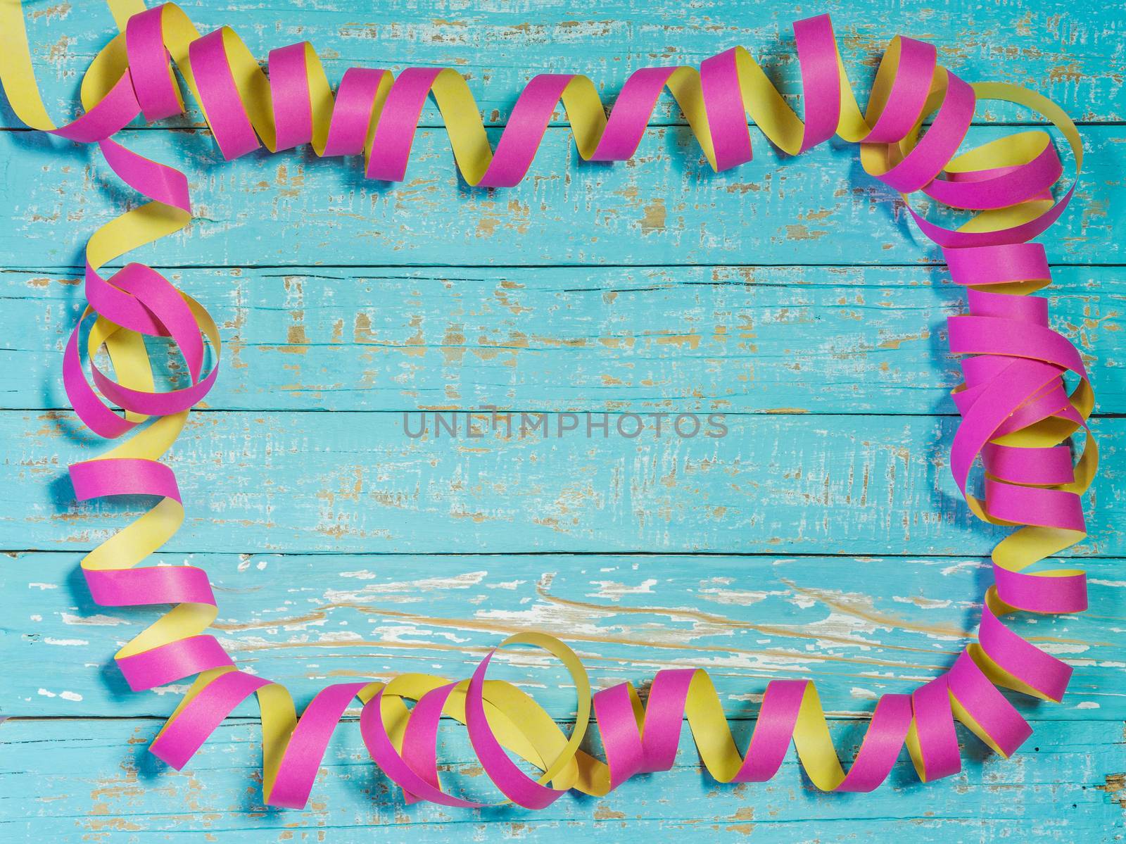 Streamers decoration on colored wood background for party or birthday celebration