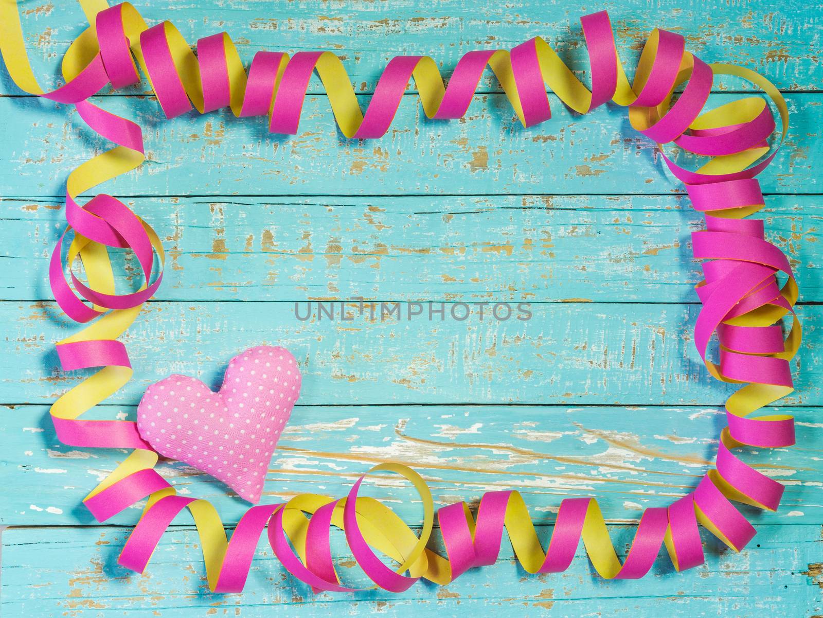 Party, birthday or carnival celebration background with pink steamers and heart
