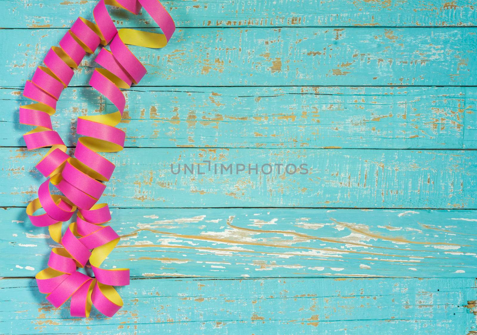 Streamers decoration on colored wood background for party or birthday celebration