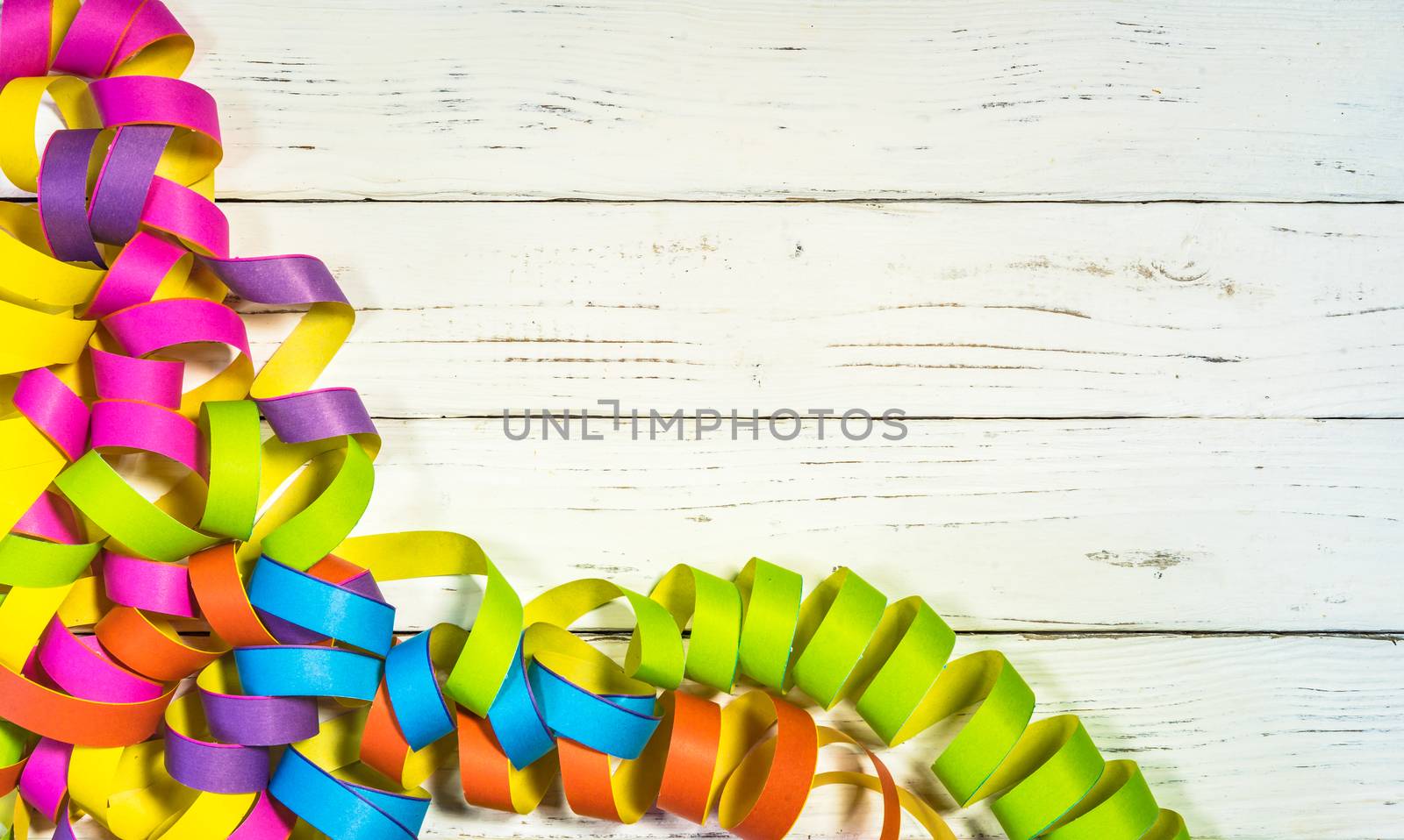 Multi-colored streamers decoration on white background for party, carnival or birthday celebration