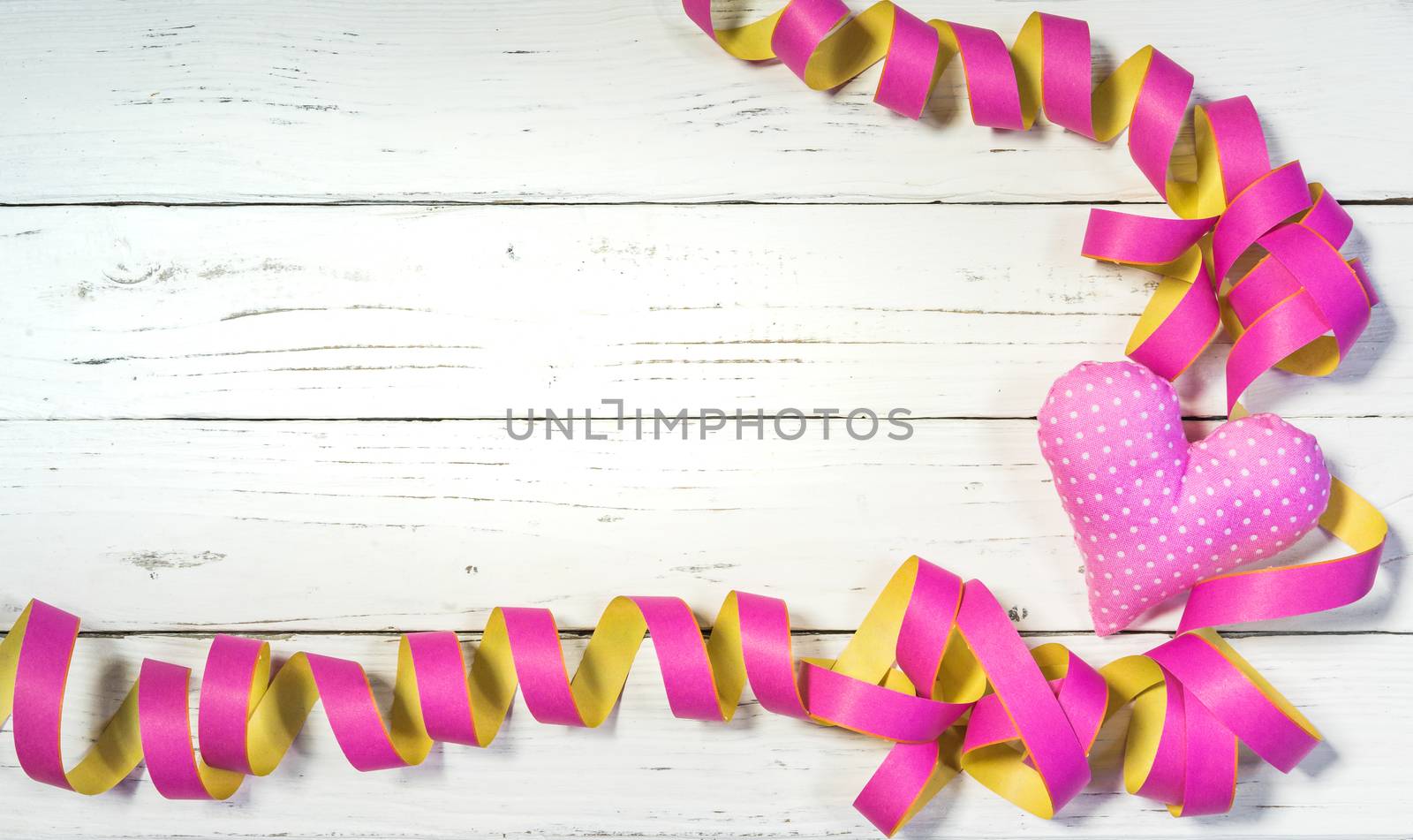 Party or birthday celebration background with streamers and pink heart decoration