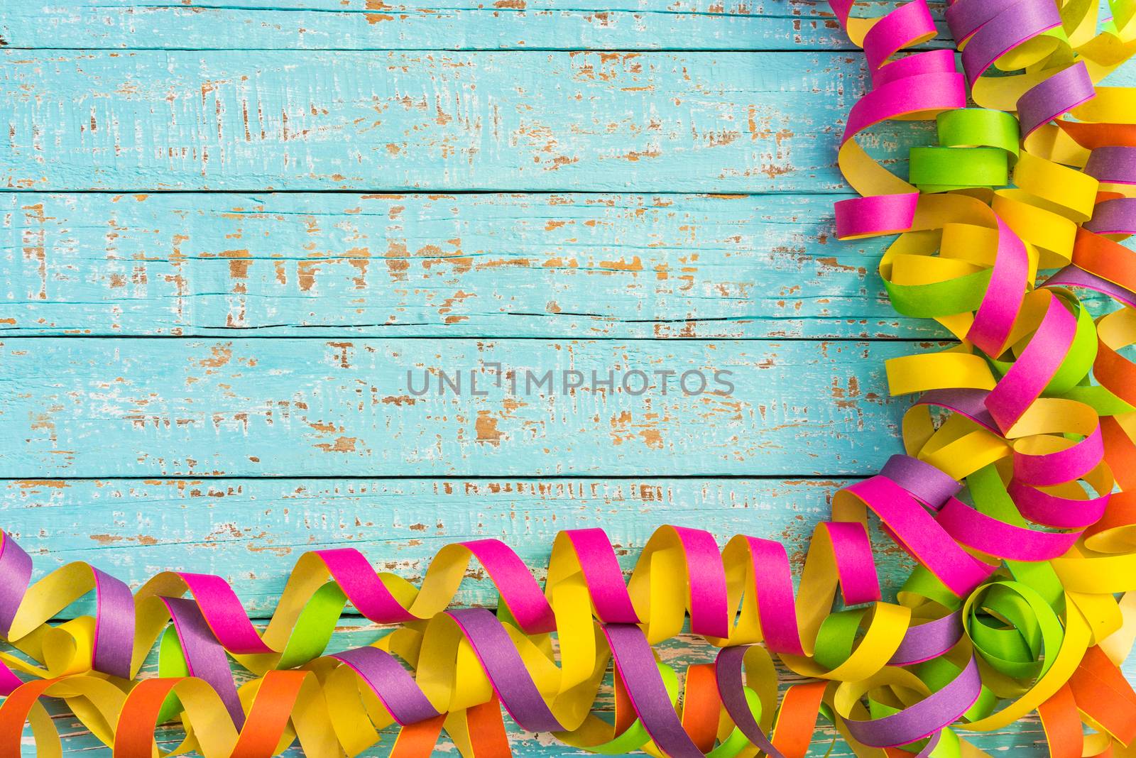 Multi-colored party, birthday or carnival celebration background with streamers and copy space